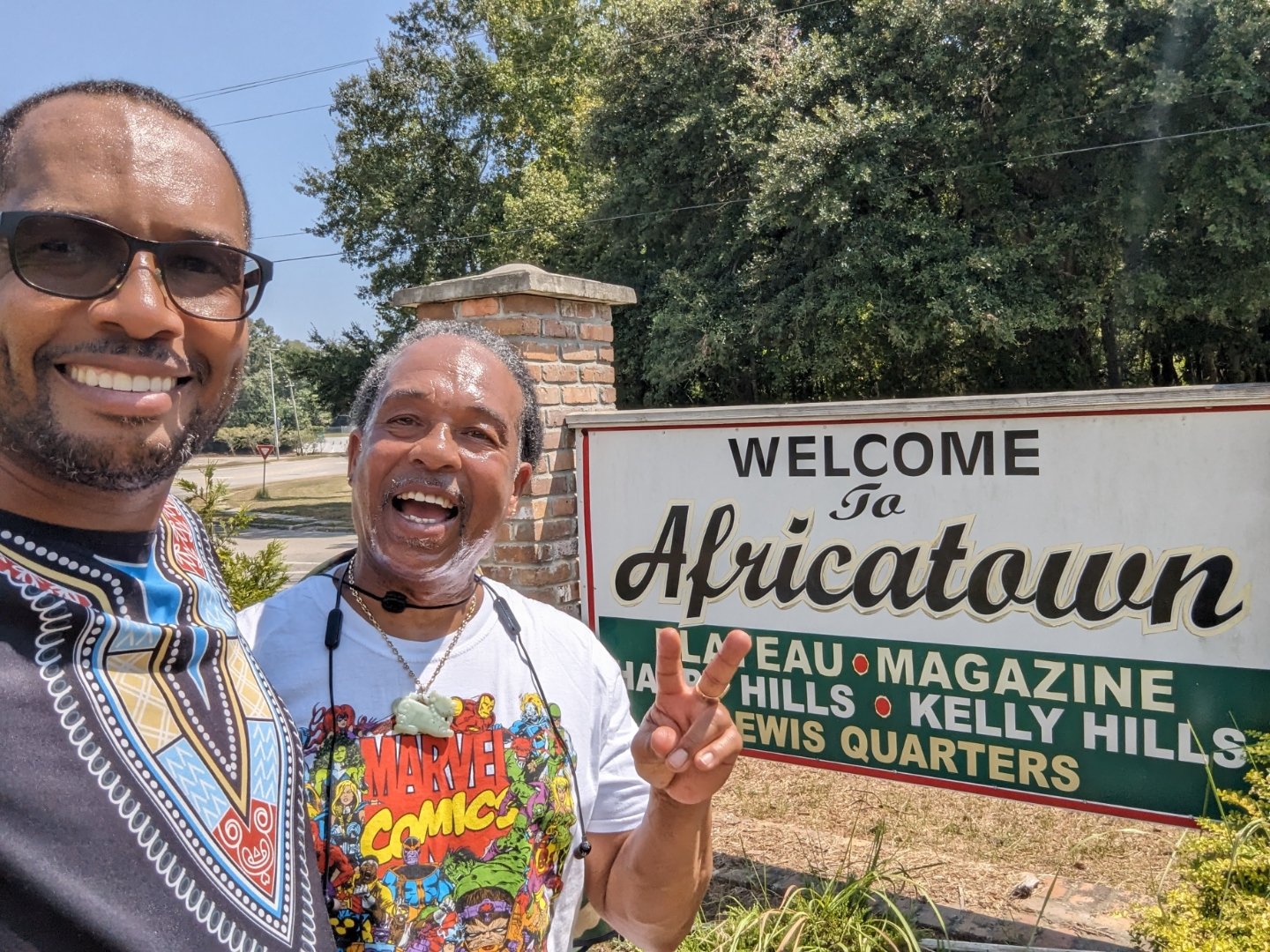 Dr. Vic Baker and his brother Tyrell at the Welcome to Africatown sign in Mobile, Alabama